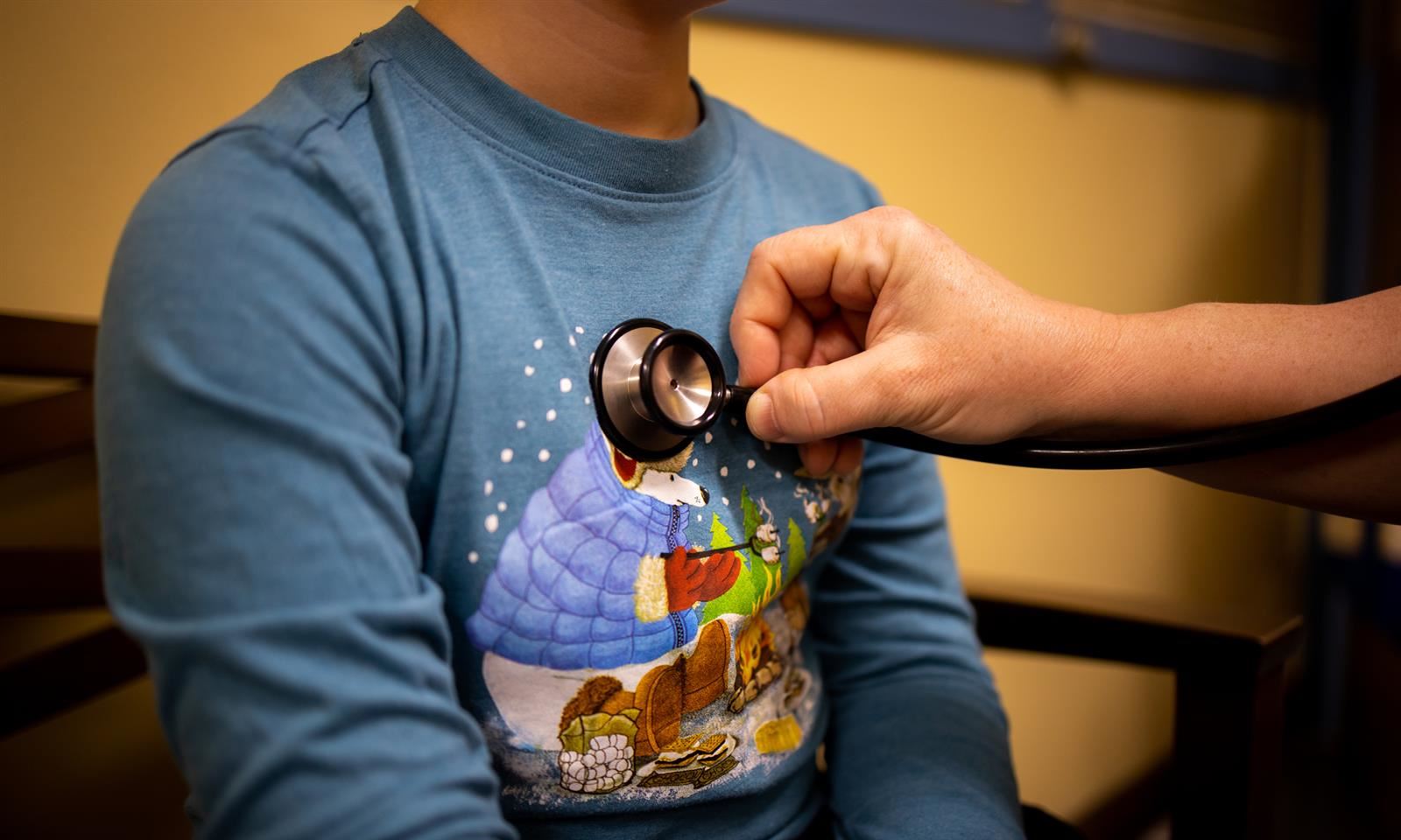Nurse checks heartbeat with stethoscope